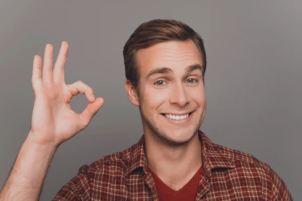 Cheerful young businessman with beaming smile gesturing "OK" — Stock Photo, Image