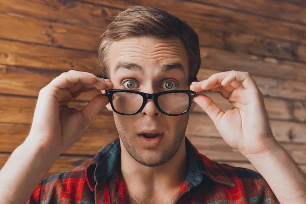 Portrait of shocked sad young man in glasses with open mouth — Stock Photo, Image