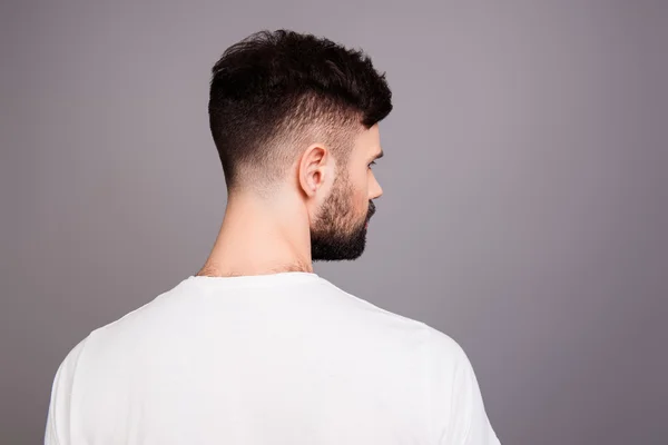 Close up portrait of man's back isolated on gray background — Stock Photo, Image