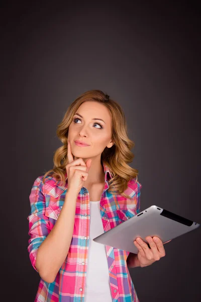 Beautiful happy young  woman holding tablet and thinking about s — Stock Photo, Image