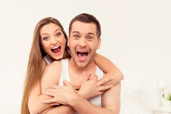 Close up portrait of man and woman screaming with funny faces