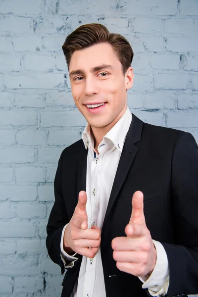 Portrait of handsome young man in suit pointing on camera — Stock Photo, Image