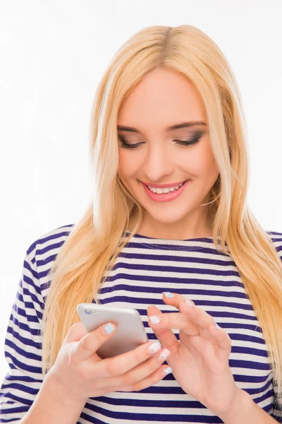 Gelukkig lachende jonge vrouw sms typen op mobiele telefoon — Stockfoto