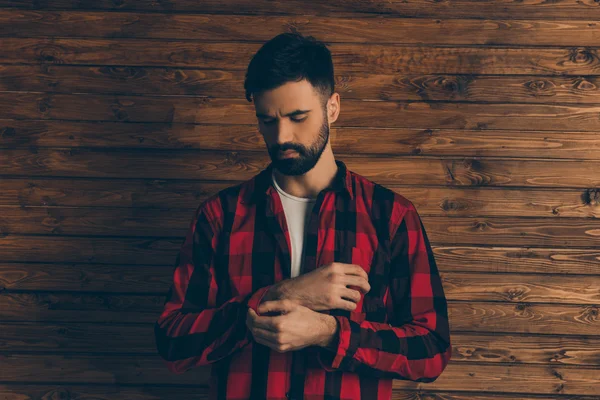 Portrait of young bearded man touching sleeve of his shirt — Stock Photo, Image