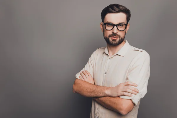 Successful young  businessman in glasses with crossed hands on g — Stock Photo, Image