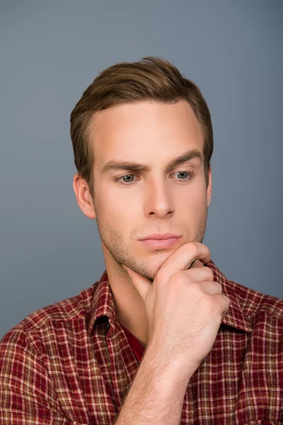 Portrait of minded handsome man touching his chin — Stock Photo, Image