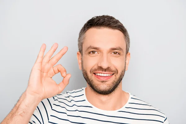 Portrait of cheerful happy young man gesturing "OK" — Stock Photo, Image