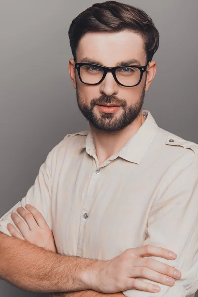 Portrait of handsome smart man in glasses with crossed hands — Stock Photo, Image