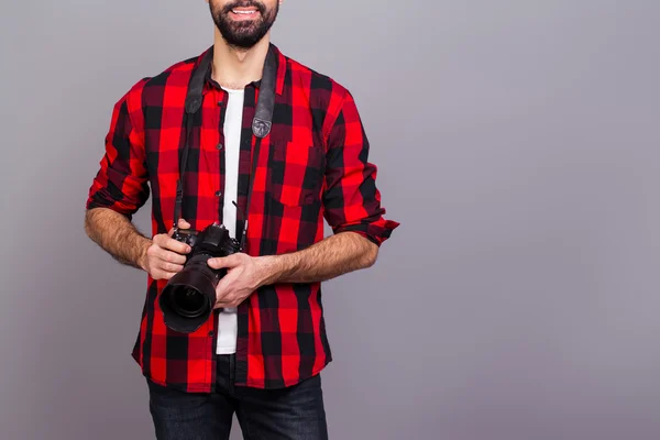 Close up photo of man in red checkered shirt holding camera — Stock Photo, Image