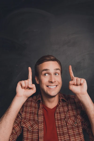 Handsome man with beaming smile gesturing with fingers under hea — Stock Photo, Image