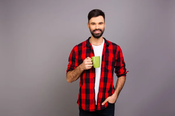 Happy pretty man holding cup of hot tea — Stock Photo, Image