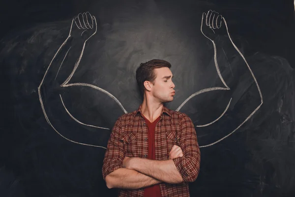 Handsome young  man kissing his painted biceps — Stock Photo, Image