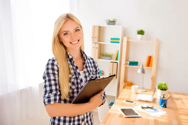 Portrait of young happy secretary holding folder with documents — Stock Photo, Image