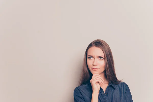 Young thoughtful pretty girl isolated on gray background — Stock Photo, Image