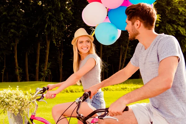 Portrait of cheerful woman riding bicycle and looking at her boy — Stock Photo, Image