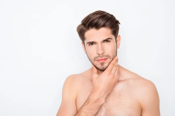 Handsome young man expertising his face before shaving — Stock Photo, Image