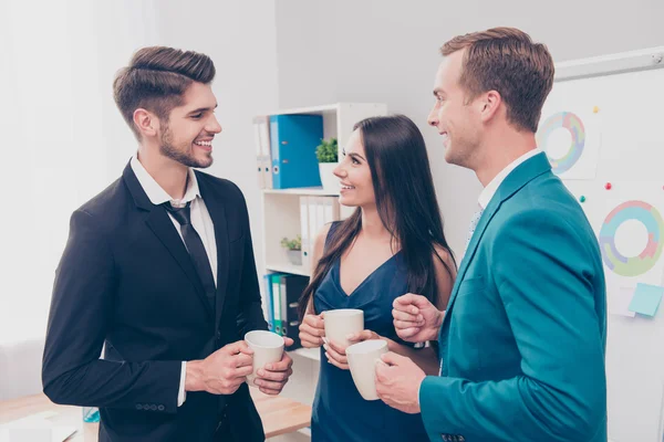 Young happy colleagues having free time and drinking coffee — Stock Photo, Image