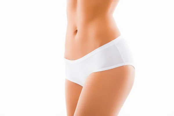 Zbliżenie zdjęcie nadające kobieta slim belly i białe majtki — Zdjęcie stockowe