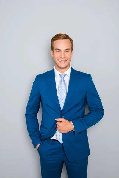 Portrait of handsome young businessman buttoning his jacket — Stock Photo, Image