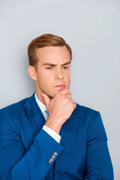 Portrait of young ponder businessman touching his chin — Stock Photo, Image