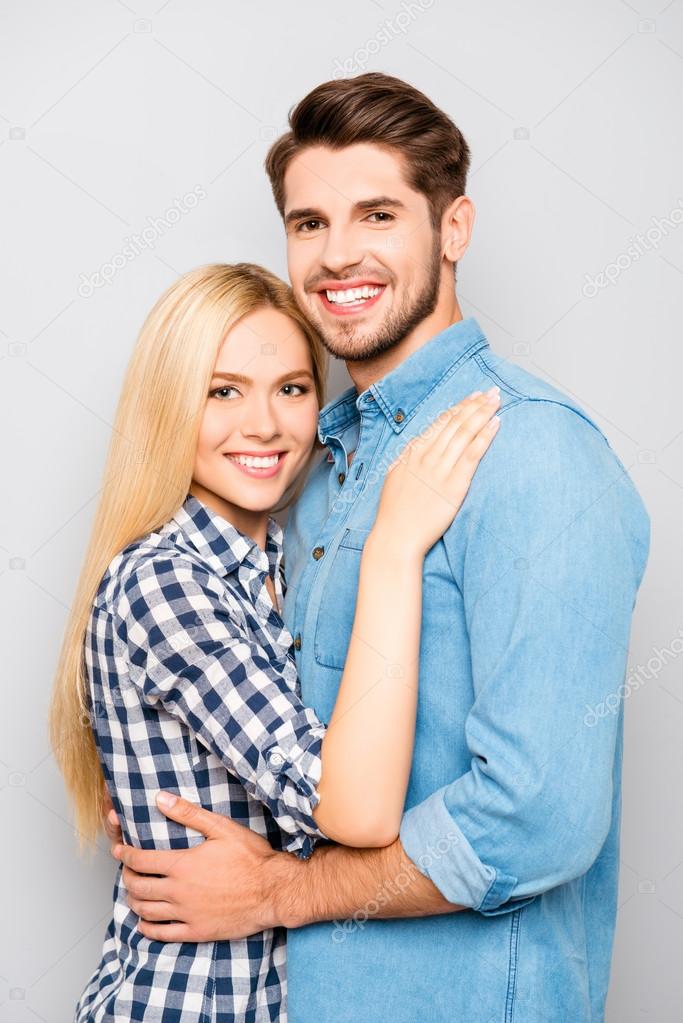 Portrait of happy cute couple in love hugs and smiling Stock Photo