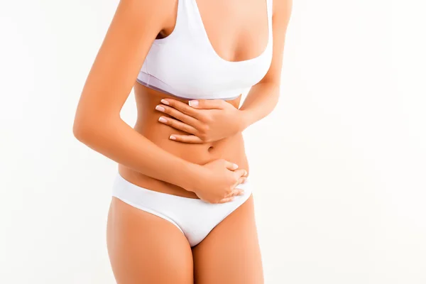 Close up of woman having abdominal pain or menstrual cramps — Stock Photo, Image