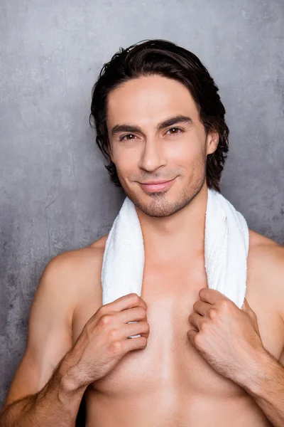 Portrait  of sexy young smiling man holding  white towel  on his — Stock Photo, Image