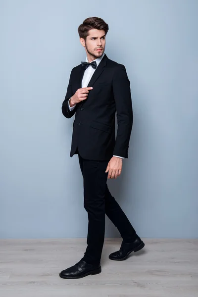 Portrait of handsome young man in black suit and bow tie — Stock Photo, Image