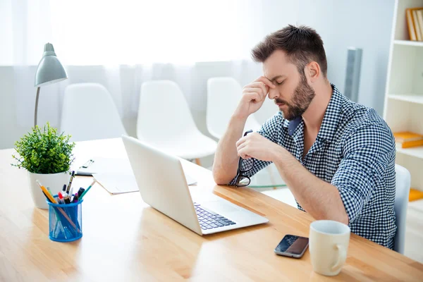 Overworked young man thinking about way to complete task — Stock Photo, Image