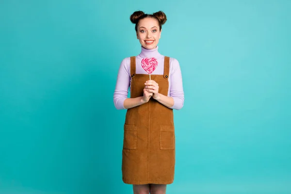 Photo of pretty sweet tooth delighted girl lady arms hold gift present pink tasty yummy stick candy wear two adorable buns fall violet pullover brown dress isolated turquoise color background — Stock Photo, Image