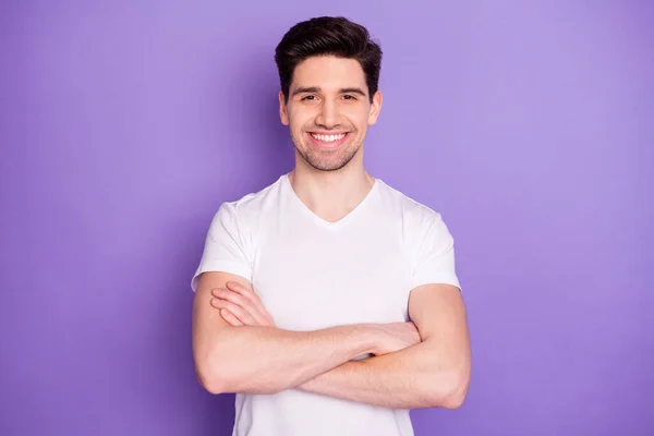 Φωτογραφία όμορφος ελκυστικός τύπος φοιτητής χέρια σταυρωμένα αυτοπεποίθηση επιχειρηματίας άντρας νέος επιτυχημένος ελεύθερος επαγγελματίας toothy χαμόγελο φορούν casual λευκό t-shirt απομονωμένο πορφυρό φόντο χρώμα — Φωτογραφία Αρχείου