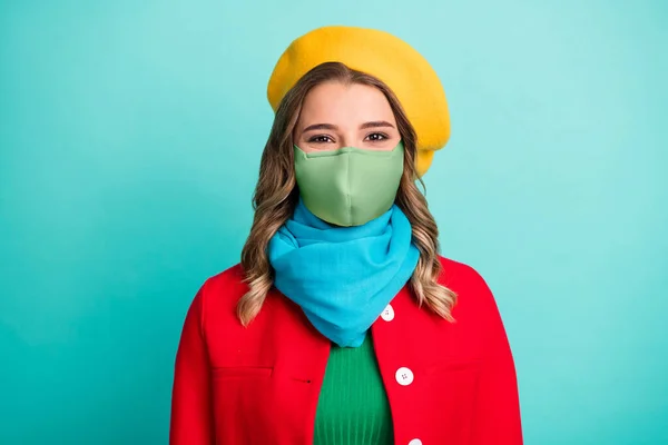 Foto de agradável encantador menina olhar câmera usar máscara outerwear brilhante isolado sobre verde azul cor fundo — Fotografia de Stock