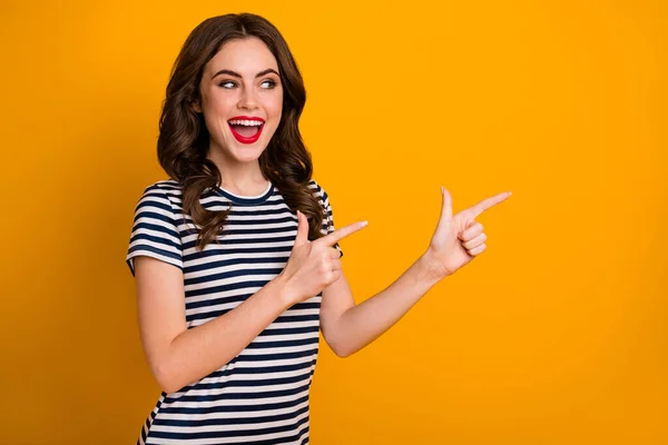 Portrait of her she nice-looking charming content happy cheerful wavy-haired girl showing ad advert isolated on bright vivid shine vibrant yellow color background — Stok Foto