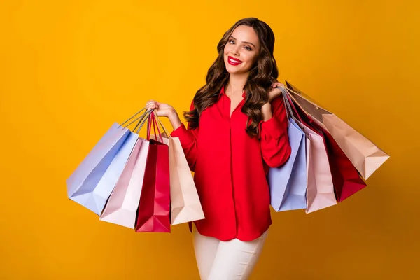 Photo of attractive pretty business lady hold carry many packs addicted shopper sale final season wear red office shirt white trousers isolated yellow vibrant color background — Stock Photo, Image