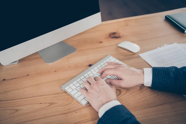 Cropped view portrait of his he professional experienced man ceo boss chief director typing on key board letter e-mail report research market sales on wooden desk work place station