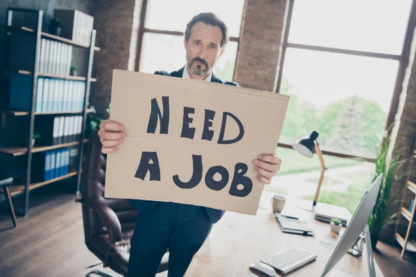 Photo of moody despair sad laid off dismissed handsome worker mature guy hold placard poster search new job last work day world crisis workplace fired bad mood modern office indoors — Stock Photo, Image