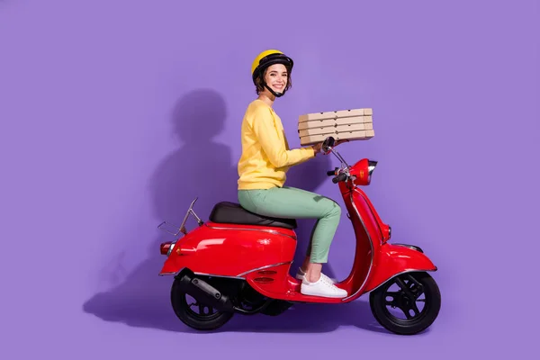 Profile side view of nice attractive pretty cheerful girl riding bike delivering bringing cafe food order fast speed service isolated bright vivid shine vibrant lilac violet purple color background