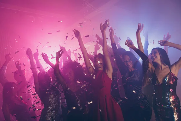 Photo of big company many fancy girls falling glitter raise arms red dress neon bright pink spotlight modern club indoors