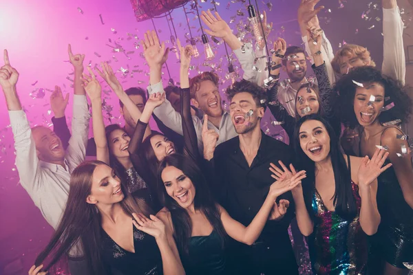 Photo of group crazy people raise hands catch falling sequins confetti wear stylish outfit modern club indoors — Stock Photo, Image