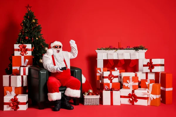 Portrait of his he attractive funky fat overweight cheerful cheery ecstatic Santa sitting in armchair play video game having fun isolated bright vivid shine vibrant red color background — Stock Photo, Image