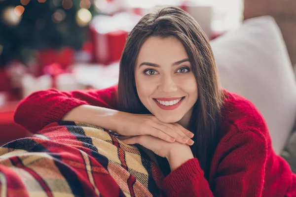 Porträtt av charmig söt flicka sitta bekväm soffa titta i kameran strålar leende i huset inomhus med x-mas firande — Stockfoto