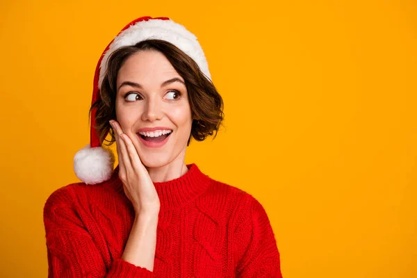 Closeup photo of funny pretty excited lady celebrate winter holidays with family dreamy look empty space wear santa claus cap red knitted sweater isolated yellow color background — Stock Photo, Image
