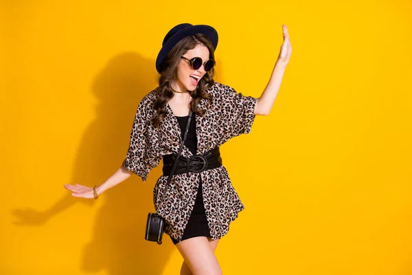 Foto de menina alegre positiva desfrutar de regozijar dança discoteca usar saia headwear óculos de sol isolado sobre brilho brilhante cor fundo — Fotografia de Stock