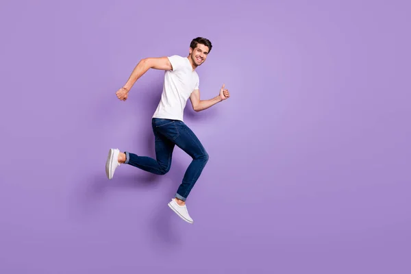 Full length body size view of his he nice attractive cheerful cheery sportive guy jumping distance isolated on bright vivid shine vibrant violet lilac purple color background — стоковое фото