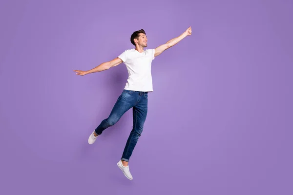 Full length body size view of his he nice attractive funky cheerful cheery guy model jumping holding invisible parasol isolated on bright vivid shine vibrant violet violet lilac purple color background — стоковое фото