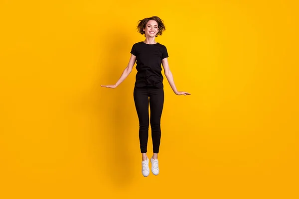 Full length body size view of lovely cheerful skinny girl jumping having fun leisure isolated bright yellow color background — Stock Photo, Image