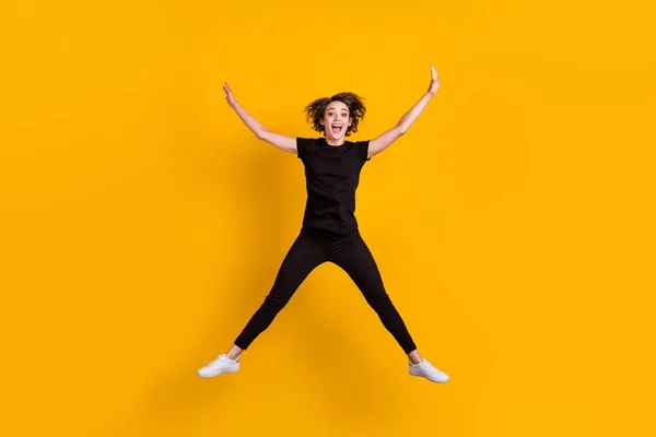 Full length body size view of skinny funky cheerful girl jumping having fun free time isolated bright yellow color background — Stock Photo, Image