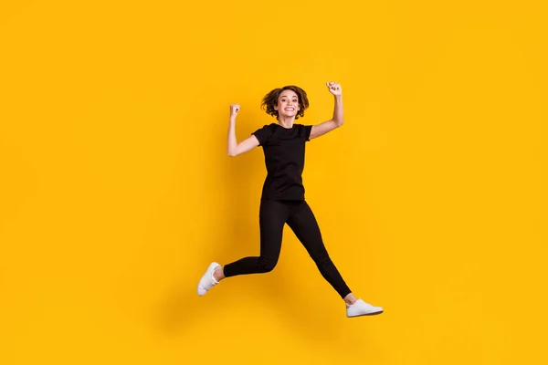 Full length body size view of slender lucky cheerful girl jumping having fun rejoicing isolated bright yellow color background — Stock Photo, Image