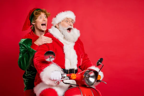 Profile photo of elf santa ride moped open mouth look empty space wear x-mas costume coat cap isolated red color background