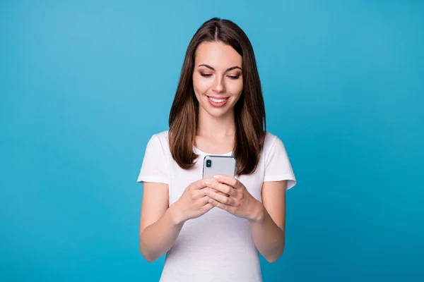 Porträtt av positiva glada flicka använda smartphone aktie prenumeration repost sociala nätverk nyheter bära bra utseende kläder isolerade över blå färg bakgrund — Stockfoto